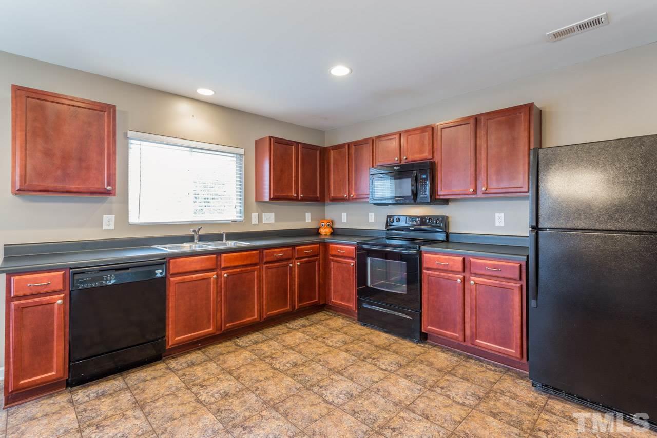 3404 Kernstown Drive Raleigh, NC 27610 - Photo 4 of 21 a kitchen with stainless steel appliances granite countertop a stove a sink dishwasher a refrigerator and a microwave oven