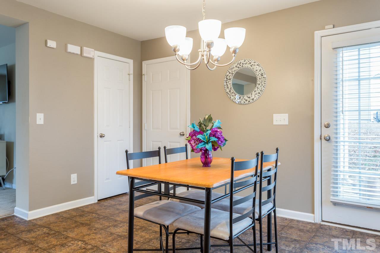 3404 Kernstown Drive Raleigh, NC 27610 - Photo 7 of 21 a view of a dining room with furniture and chandelier