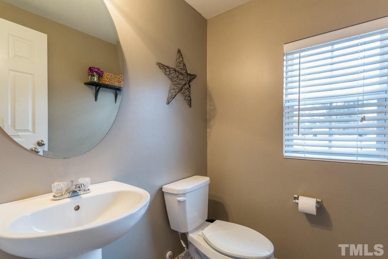 3404 Kernstown Drive Raleigh, NC 27610 - Photo 8 of 21 a bathroom with a sink toilet and a mirror