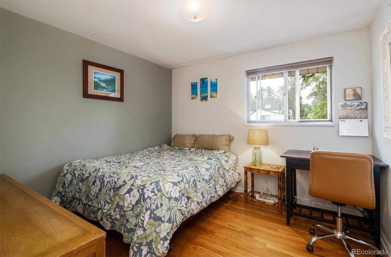 8633 West 44th Place Wheat Ridge, CO 80033 - Photo 13 of 30 a bedroom that has a bed and a chair in it