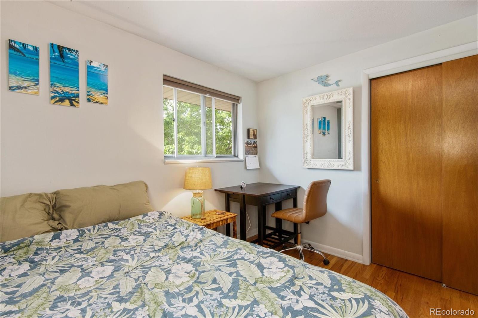 8633 West 44th Place Wheat Ridge, CO 80033 - Photo 14 of 30 a bedroom with a bed and a table in it