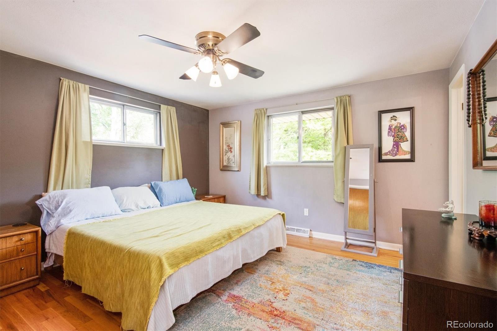 8633 West 44th Place Wheat Ridge, CO 80033 - Photo 16 of 30 a bedroom with a bed and wooden floor