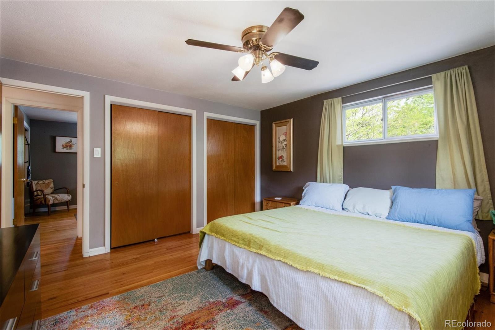 8633 West 44th Place Wheat Ridge, CO 80033 - Photo 18 of 30 a bedroom with a large bed and a window