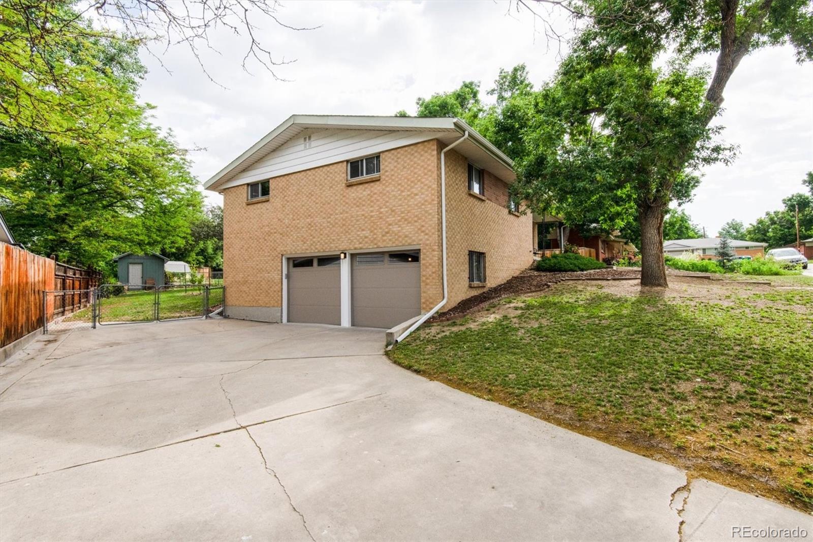 8633 West 44th Place Wheat Ridge, CO 80033 - Photo 25 of 30 a view of a backyard with a garden and tree