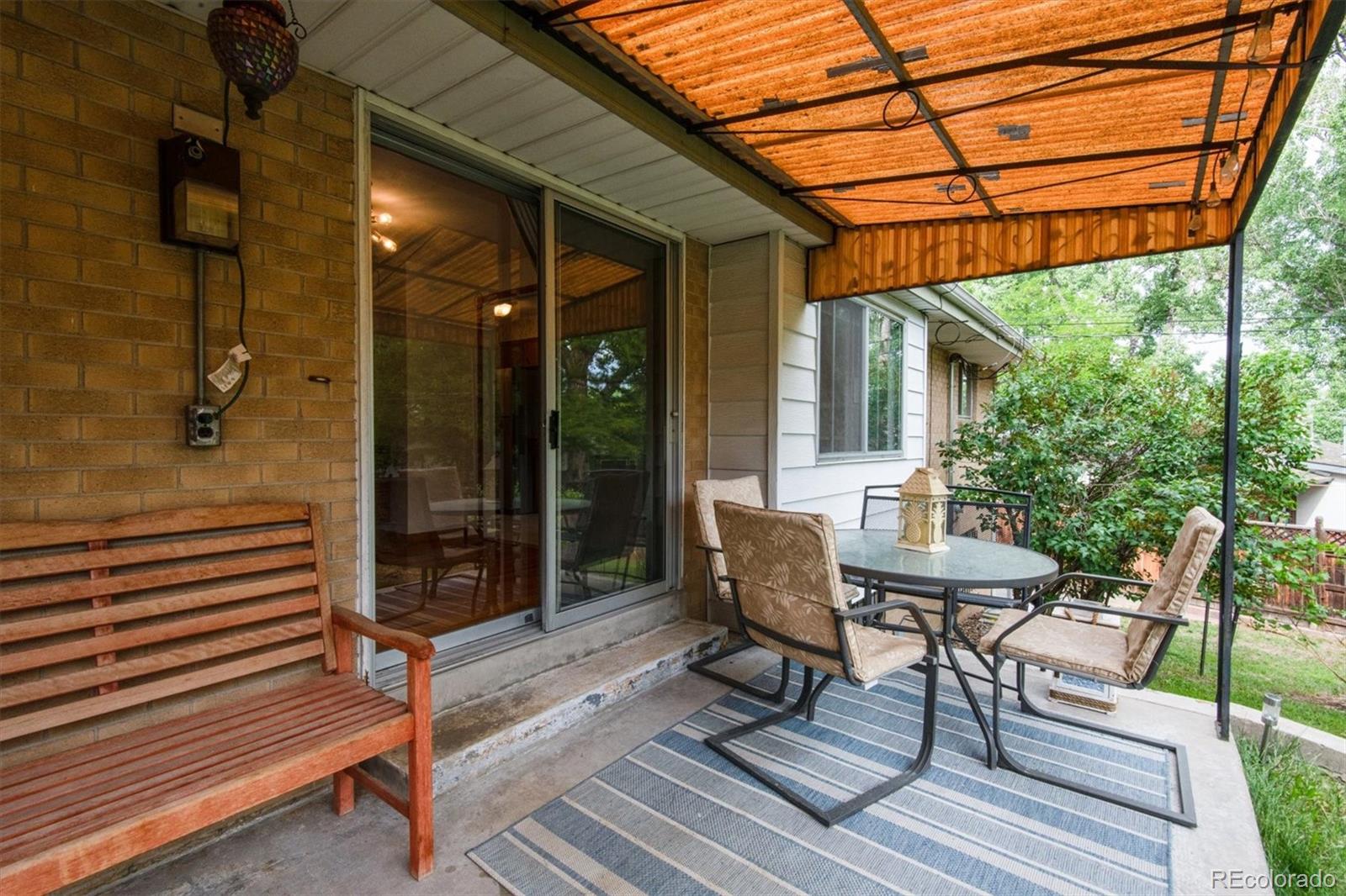 8633 West 44th Place Wheat Ridge, CO 80033 - Photo 26 of 30 a view of a chairs and a tables in the patio
