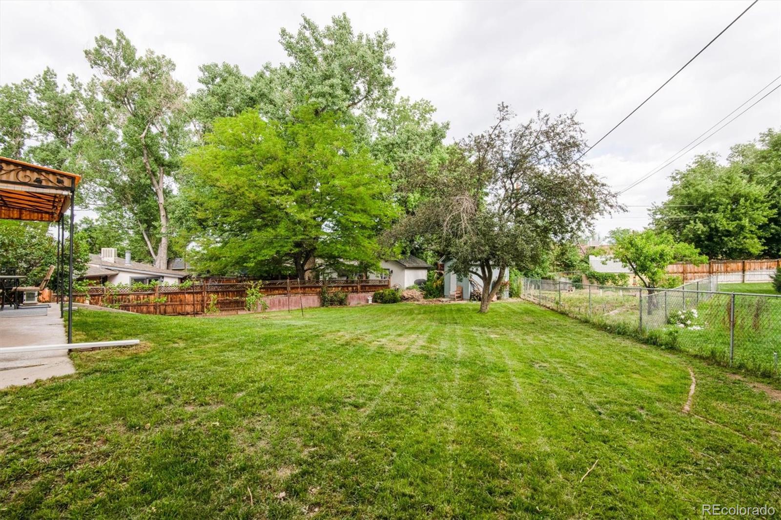 8633 West 44th Place Wheat Ridge, CO 80033 - Photo 27 of 30 a view of yard with swimming pool and green space