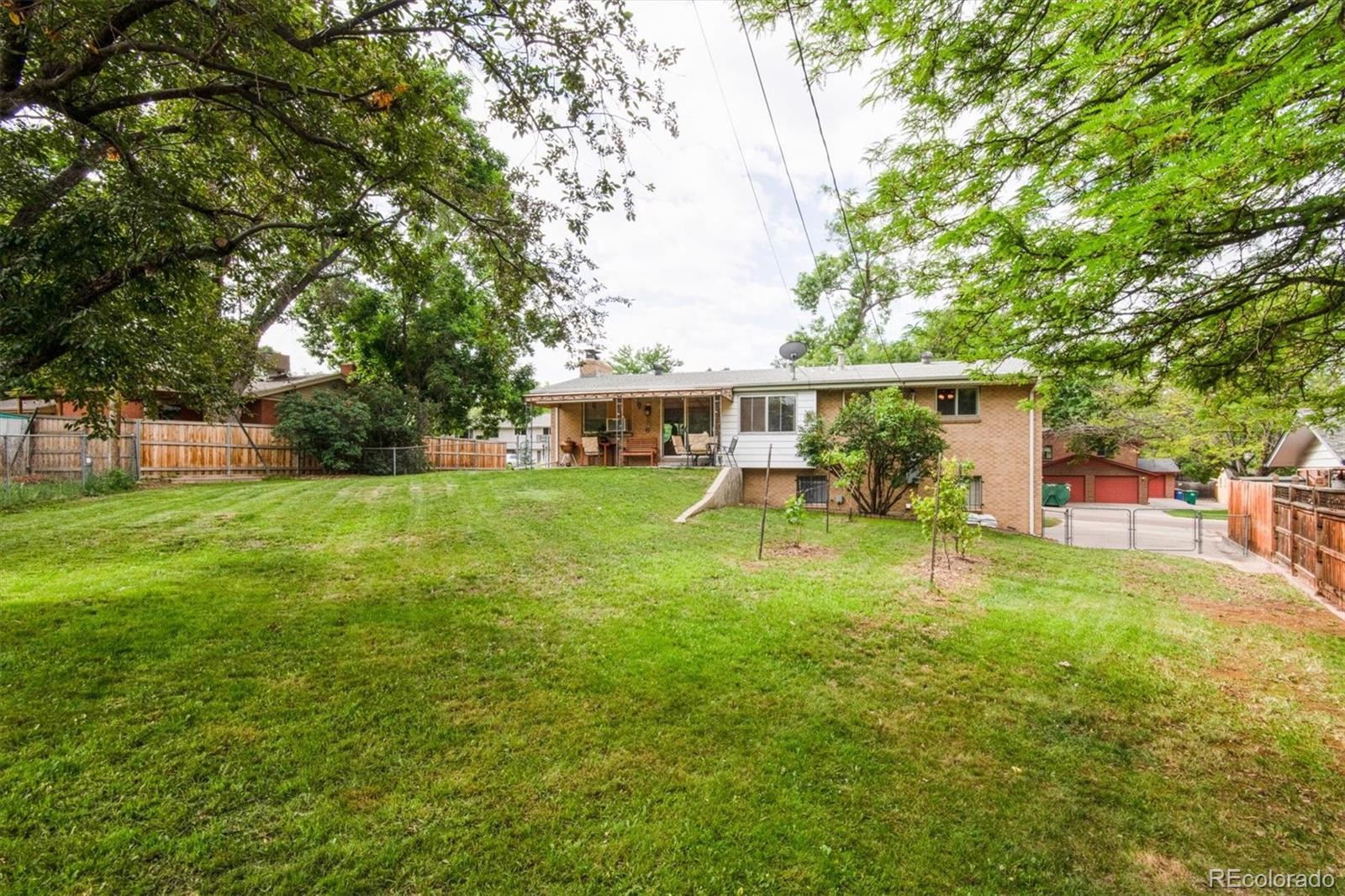8633 West 44th Place Wheat Ridge, CO 80033 - Photo 28 of 30 front view of a house with a big yard