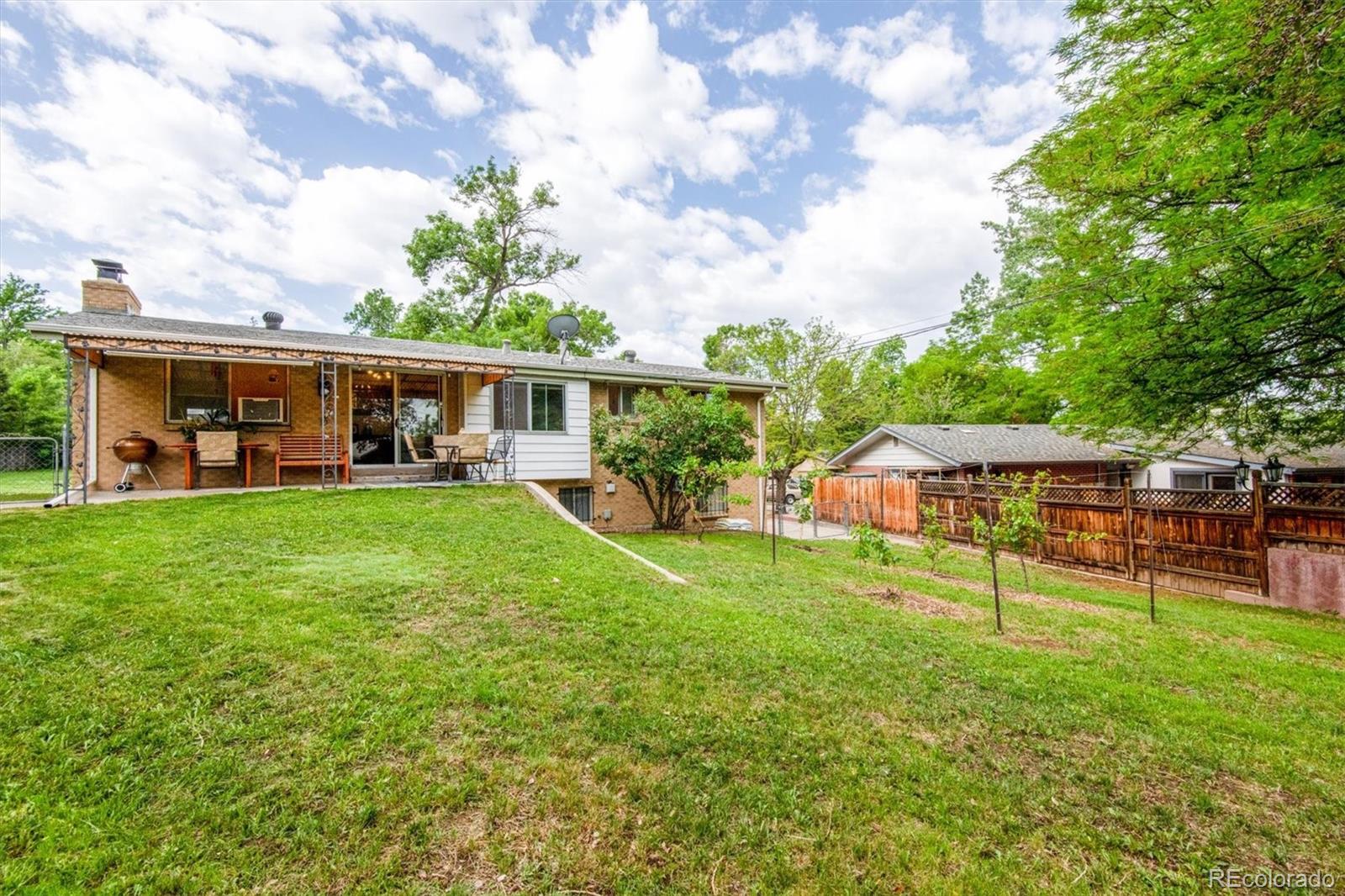 8633 West 44th Place Wheat Ridge, CO 80033 - Photo 29 of 30 a view of a house with a backyard porch and sitting area