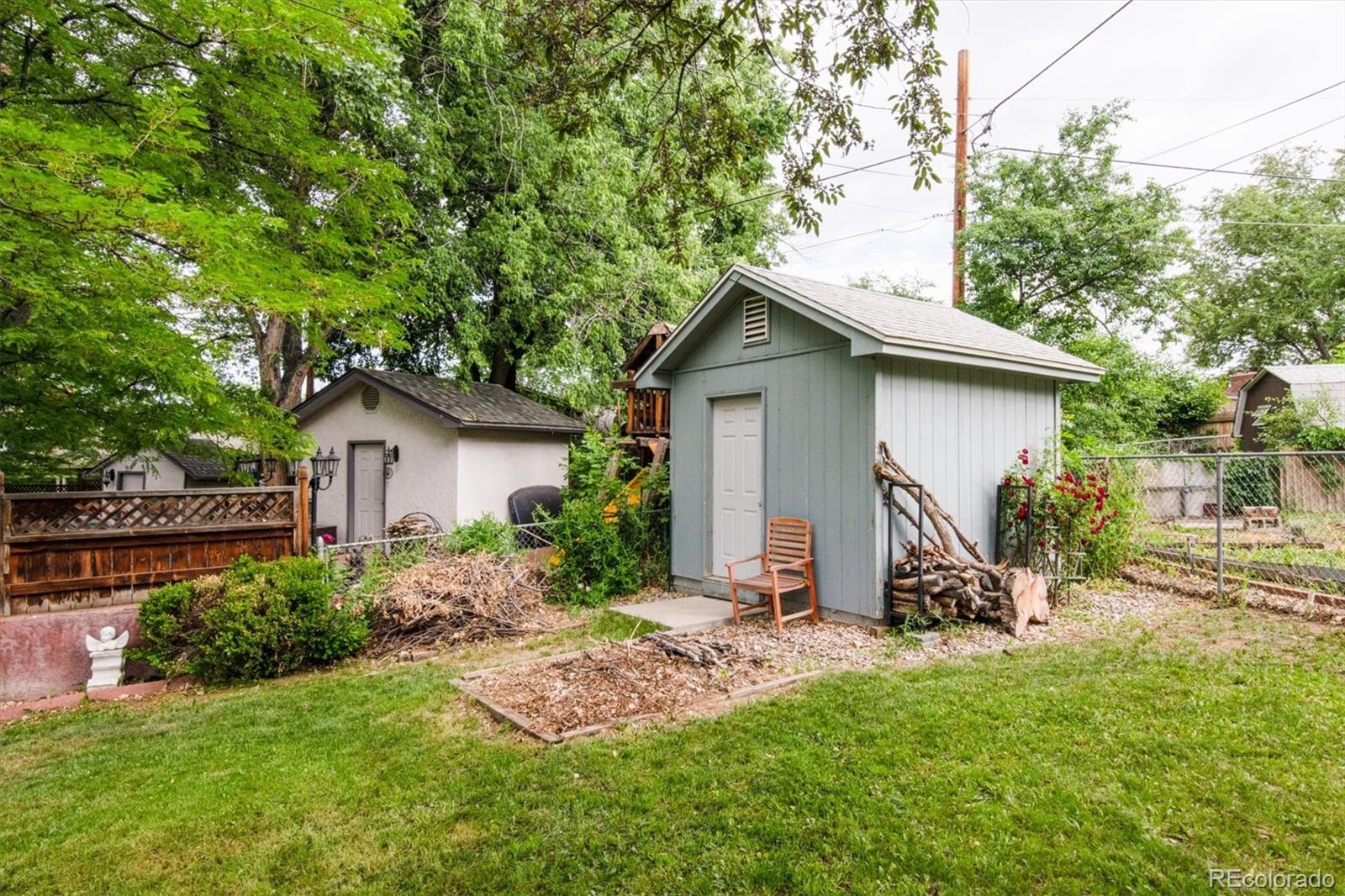 8633 West 44th Place Wheat Ridge, CO 80033 - Photo 30 of 30 a view of a house with a yard and plants