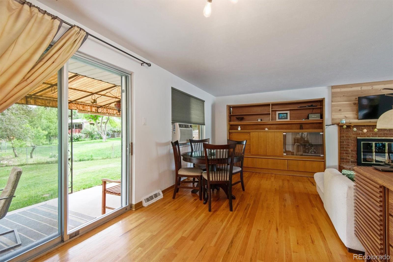 8633 West 44th Place Wheat Ridge, CO 80033 - Photo 8 of 30 a dining room with furniture and wooden floor
