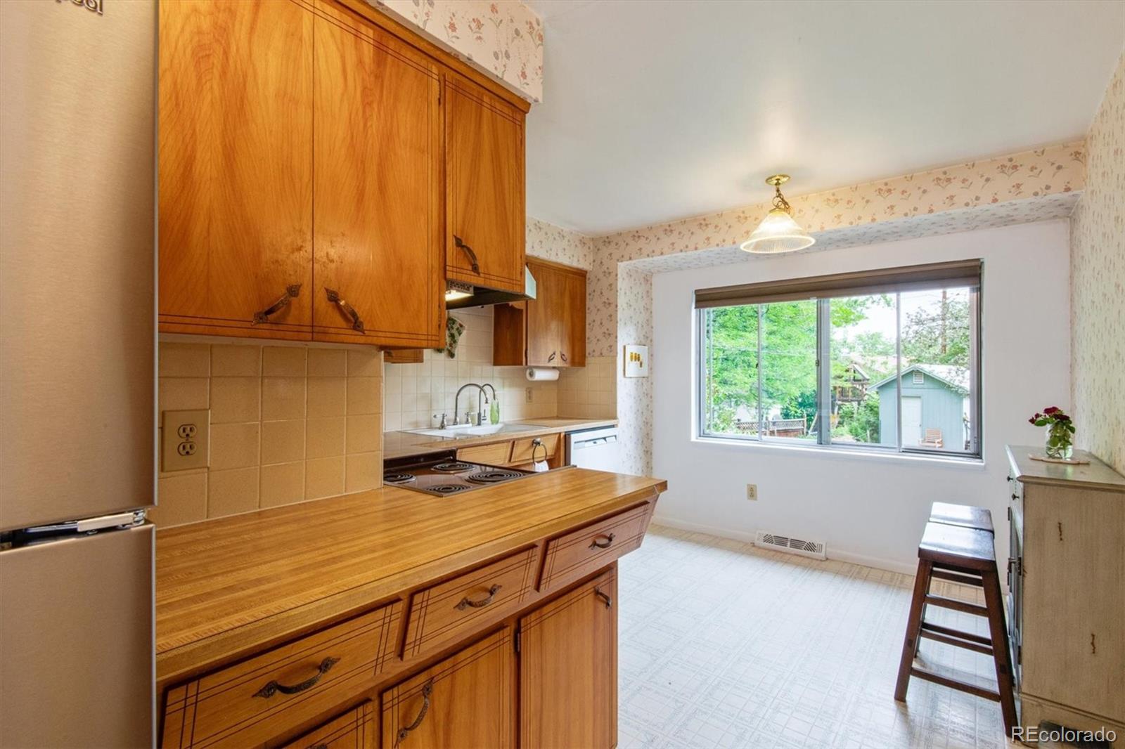 8633 West 44th Place Wheat Ridge, CO 80033 - Photo 9 of 30 a view of a kitchen with a sink and cabinets