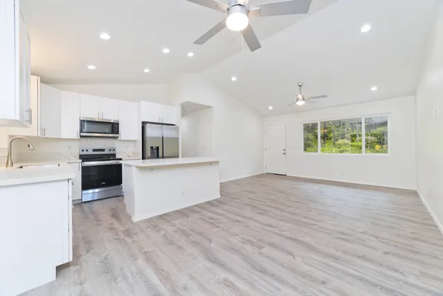 a bathroom with a granite countertop sink a toilet and bathtub