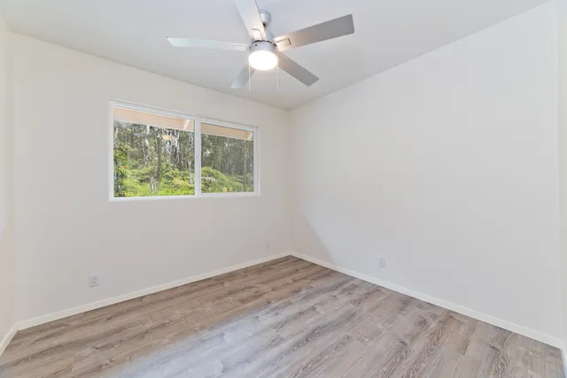 a bedroom with a large bed and a potted plant