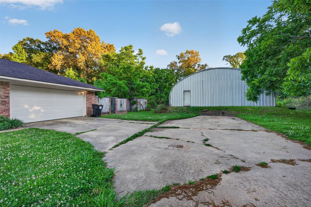 401 Cane Bend Drive Haughton, LA 71037 - Photo 21 of 27 a front view of a house with a yard and a garage