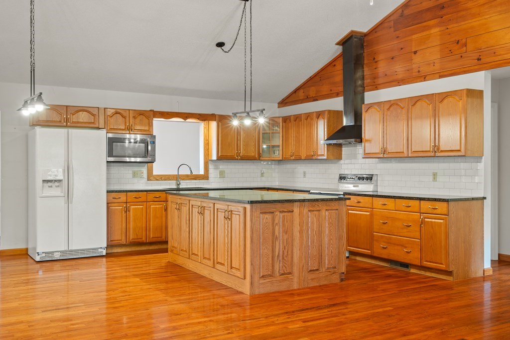 2421 Settlers Ridge Road Hiawassee, GA 30546 - Photo 15 of 46 a kitchen with stainless steel appliances granite countertop a sink a stove cabinets and wooden floor
