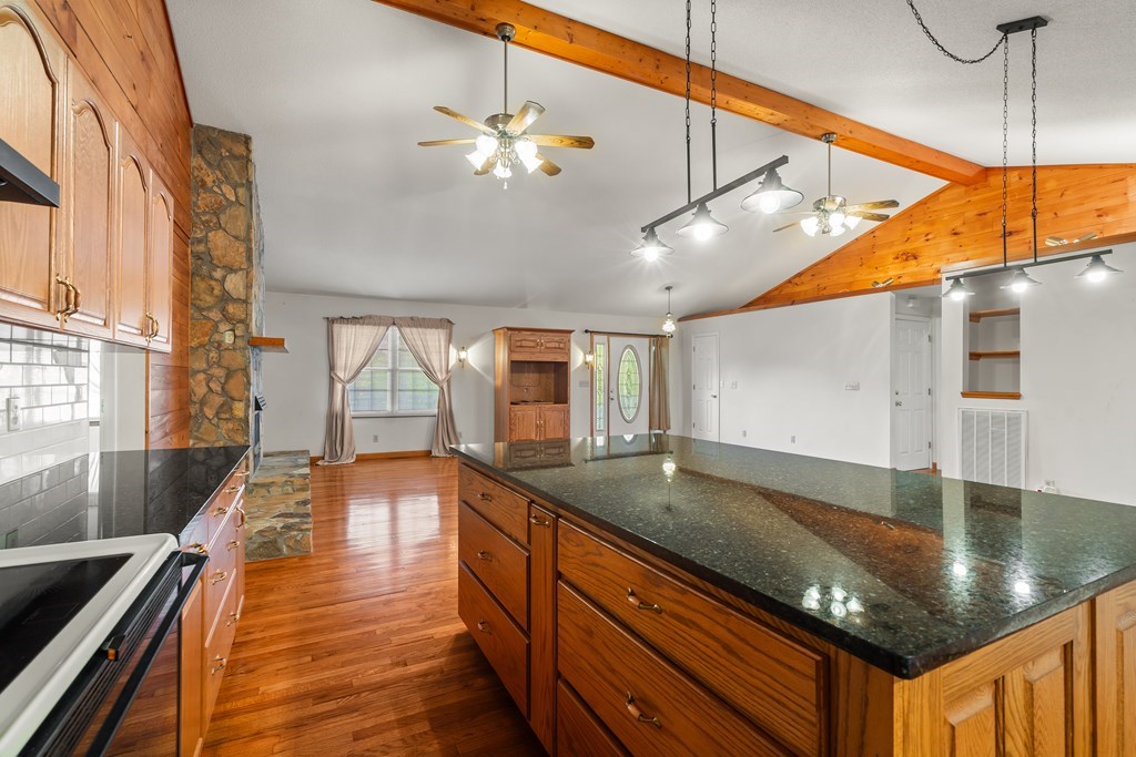 2421 Settlers Ridge Road Hiawassee, GA 30546 - Photo 21 of 46 a kitchen with stainless steel appliances granite countertop a sink a stove and a wooden cabinets
