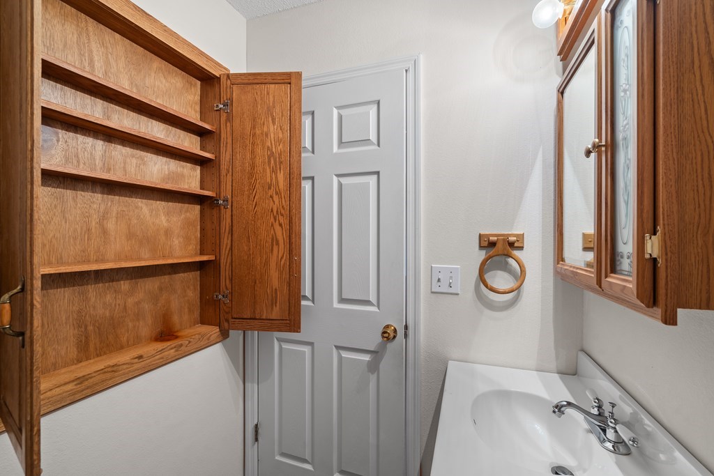 2421 Settlers Ridge Road Hiawassee, GA 30546 - Photo 27 of 46 a bathroom with a sink and a mirror
