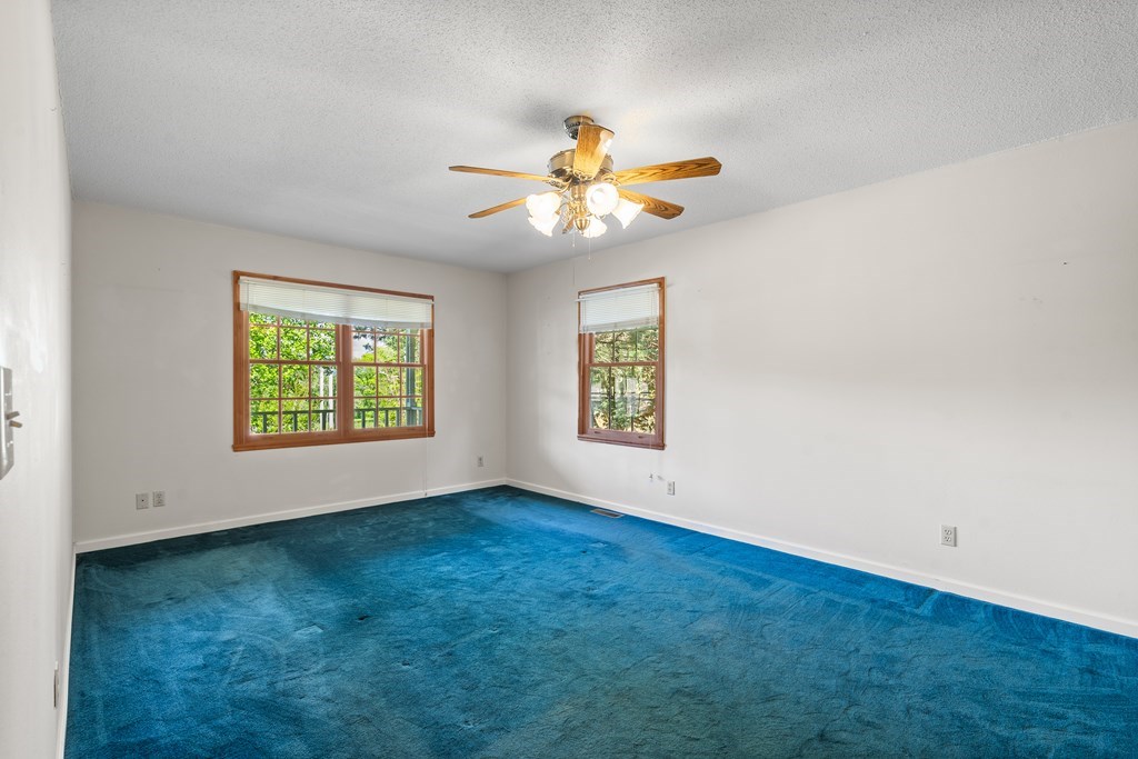 2421 Settlers Ridge Road Hiawassee, GA 30546 - Photo 29 of 46 an empty room with windows and fan