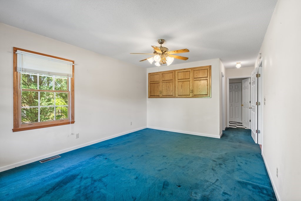 2421 Settlers Ridge Road Hiawassee, GA 30546 - Photo 30 of 46 an empty room with a window and a ceiling fan
