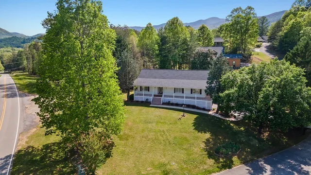 an aerial view of a house with a yard