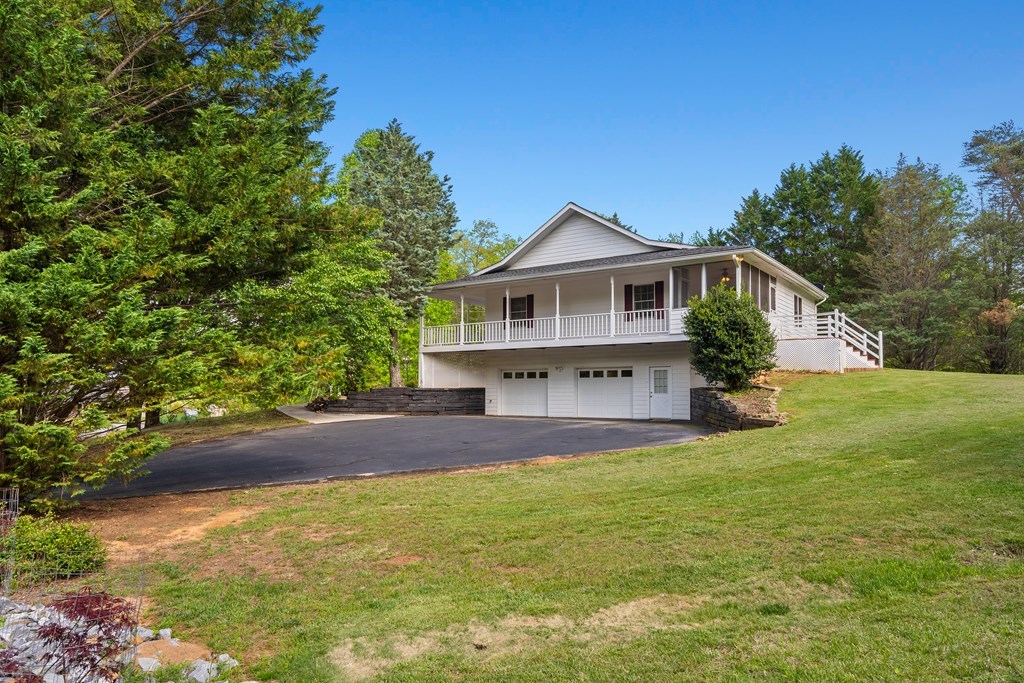 2421 Settlers Ridge Road Hiawassee, GA 30546 - Photo 6 of 46 a front view of a house with yard and green space