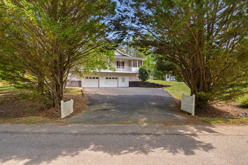 2421 Settlers Ridge Road Hiawassee, GA 30546 - Photo 8 of 46 a front view of a house with a yard and garage
