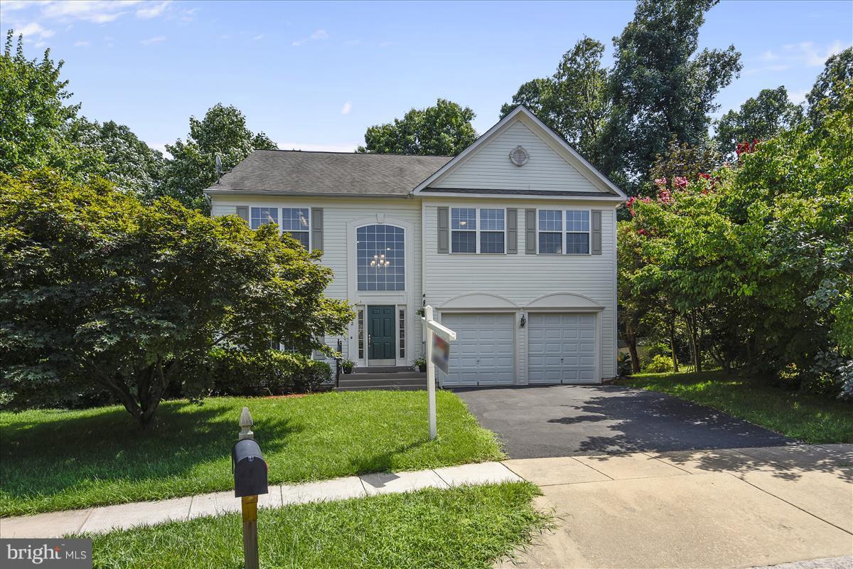 12902 Summit Ridge Terrace Germantown, MD 20874 - Photo 1 of 30 a front view of a house with a yard and trees