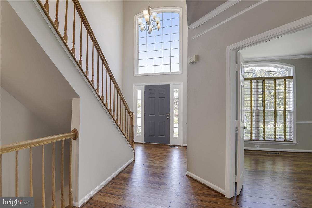 12902 Summit Ridge Terrace Germantown, MD 20874 - Photo 2 of 30 a view of front door with wooden floor and stairs