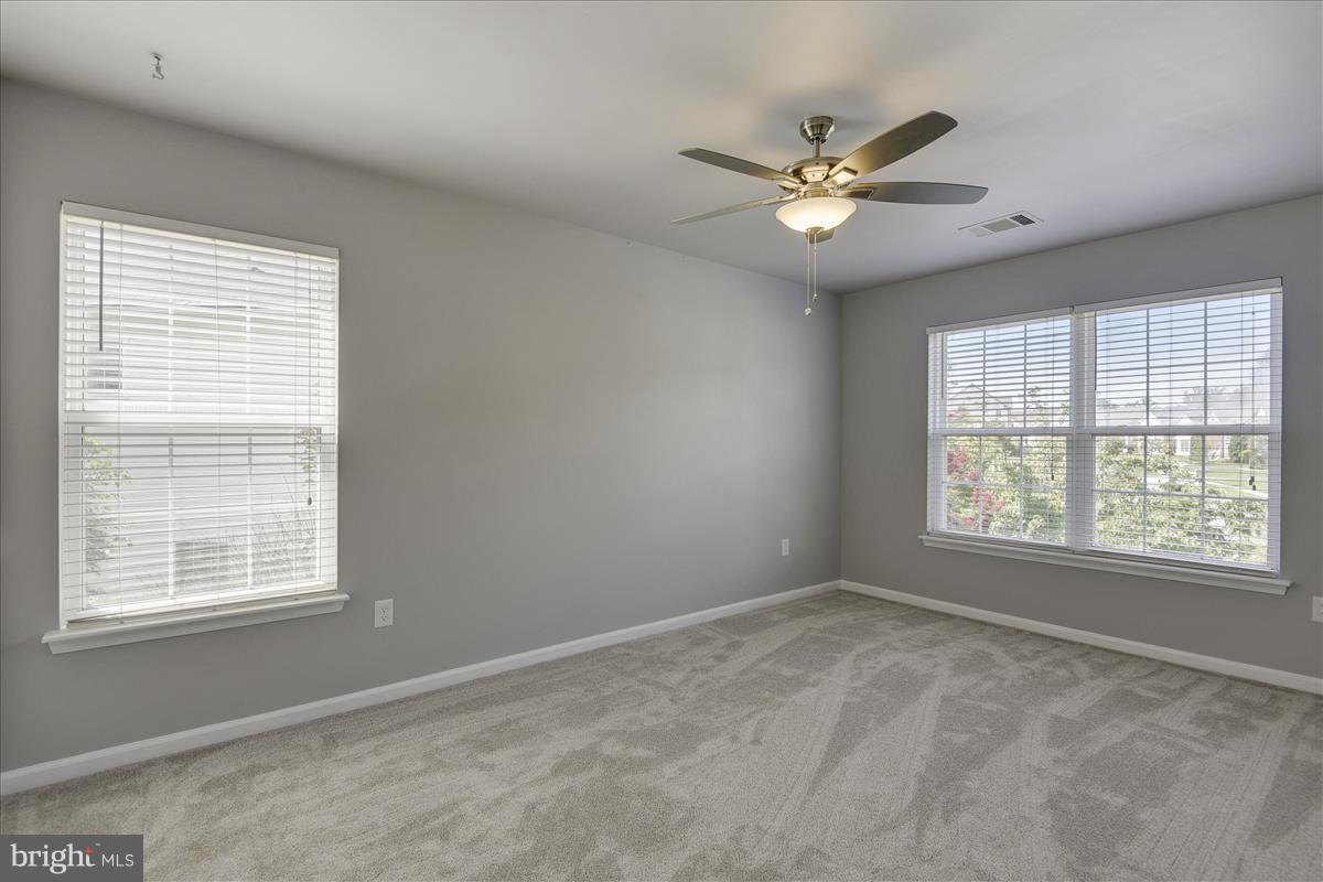 12902 Summit Ridge Terrace Germantown, MD 20874 - Photo 17 of 30 a view of a livingroom with a ceiling fan and window