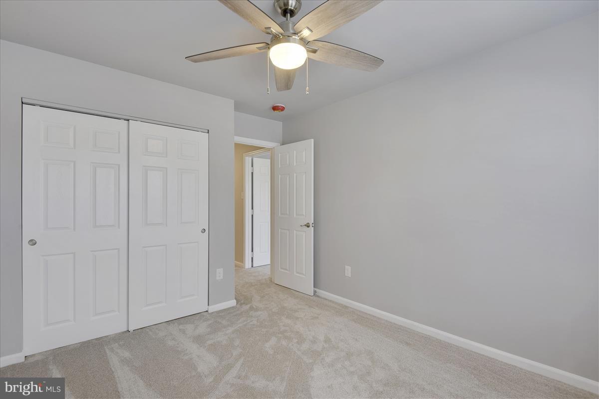 12902 Summit Ridge Terrace Germantown, MD 20874 - Photo 19 of 30 an empty room with closet and a chandelier fan