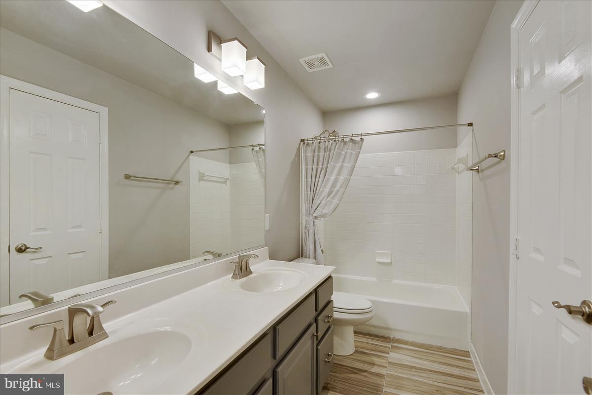 12902 Summit Ridge Terrace Germantown, MD 20874 - Photo 20 of 30 a bathroom with a sink a toilet and shower