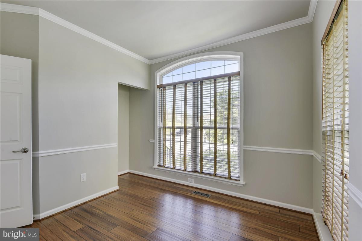 12902 Summit Ridge Terrace Germantown, MD 20874 - Photo 3 of 30 a view of an empty room with wooden floor and a window