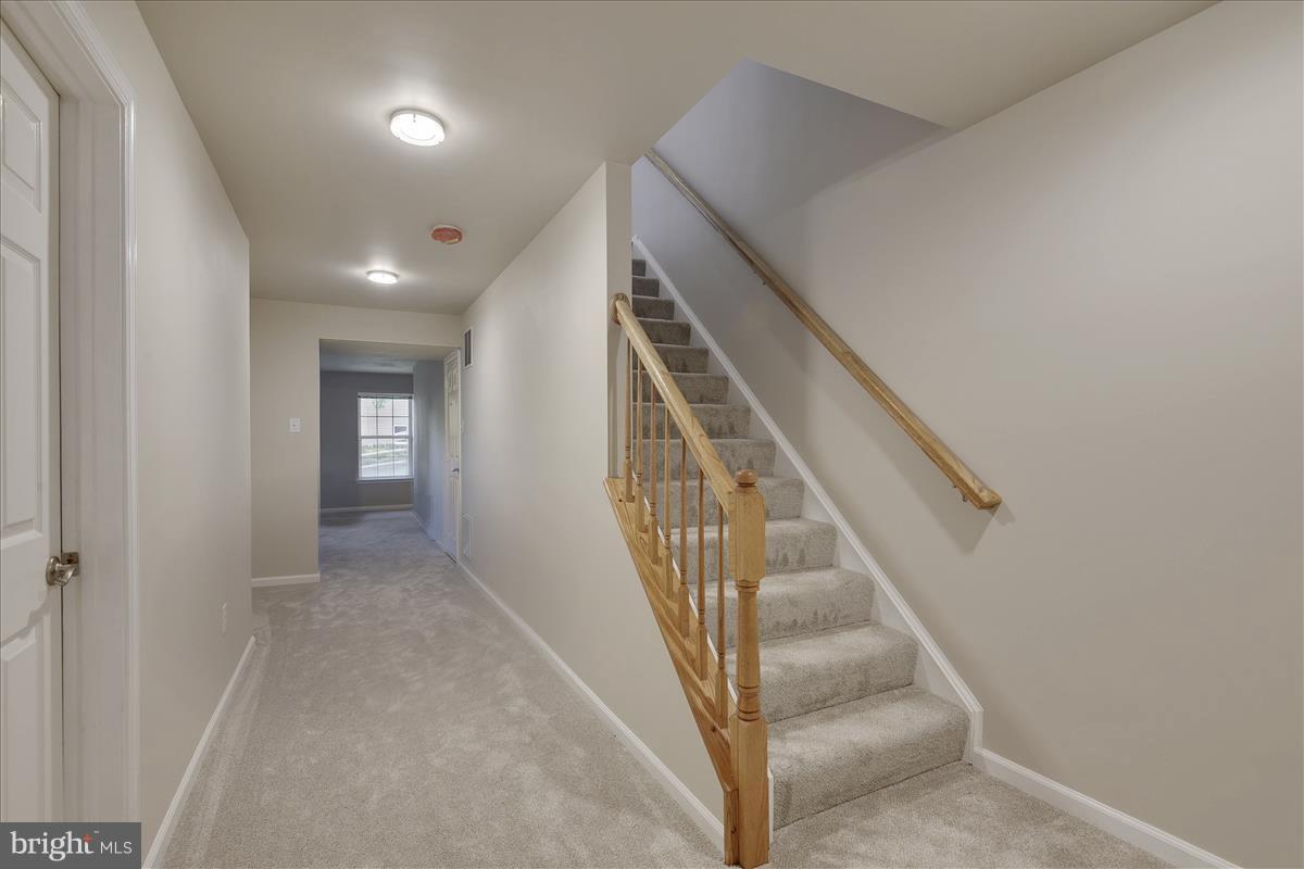 12902 Summit Ridge Terrace Germantown, MD 20874 - Photo 26 of 30 a view of staircase with white walls and white walls