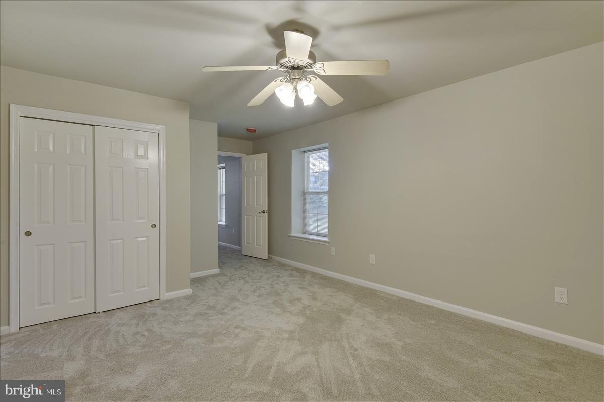 12902 Summit Ridge Terrace Germantown, MD 20874 - Photo 29 of 30 an empty room with chandelier fan and windows