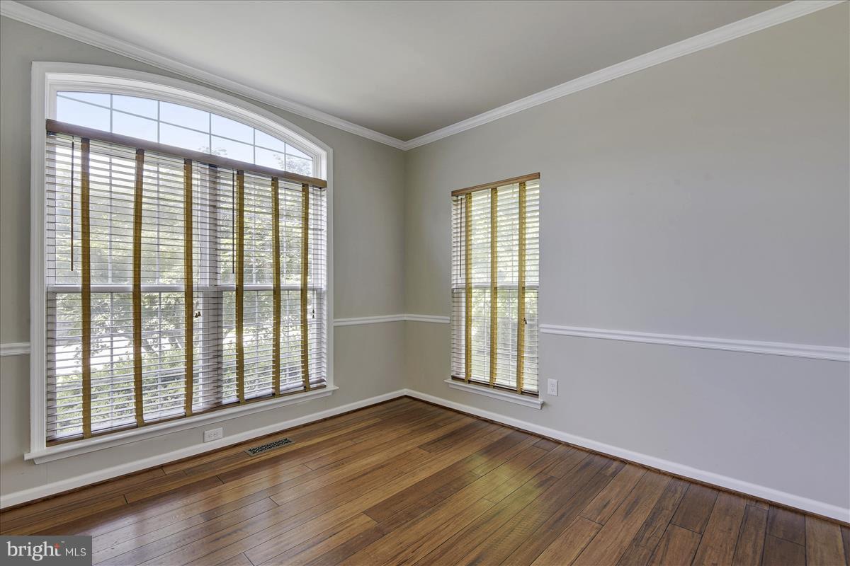 12902 Summit Ridge Terrace Germantown, MD 20874 - Photo 4 of 30 a view of an empty room with wooden floor and a window
