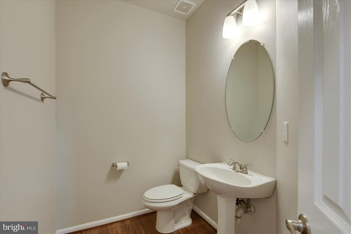 12902 Summit Ridge Terrace Germantown, MD 20874 - Photo 5 of 30 a bathroom with a sink mirror and toilet