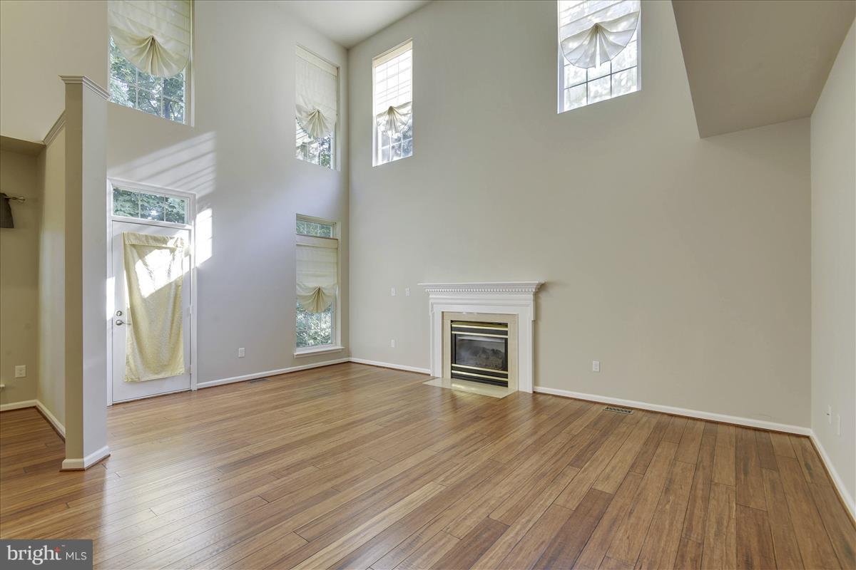 12902 Summit Ridge Terrace Germantown, MD 20874 - Photo 10 of 30 a view of empty room with wooden floor and fan
