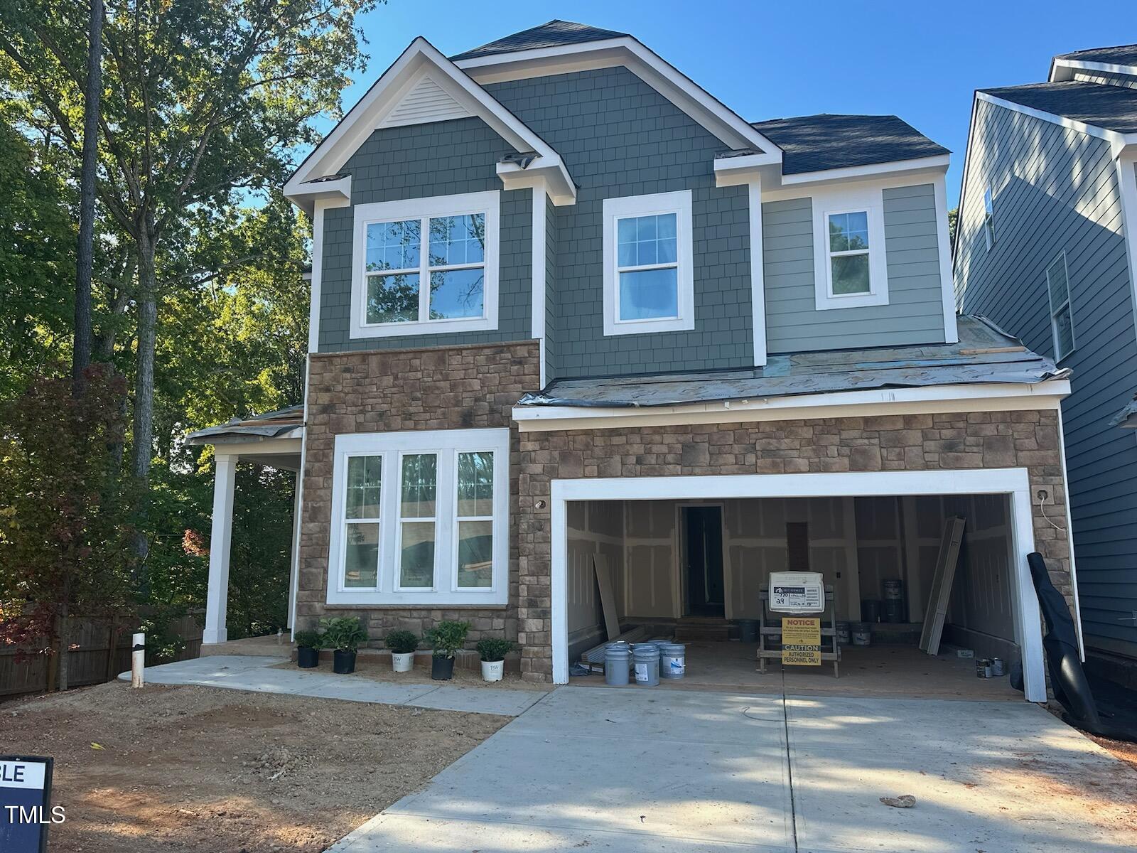 7701 Litcham Drive Raleigh, NC 27615 - Photo 1 of 58 a front view of a house with a yard and garage