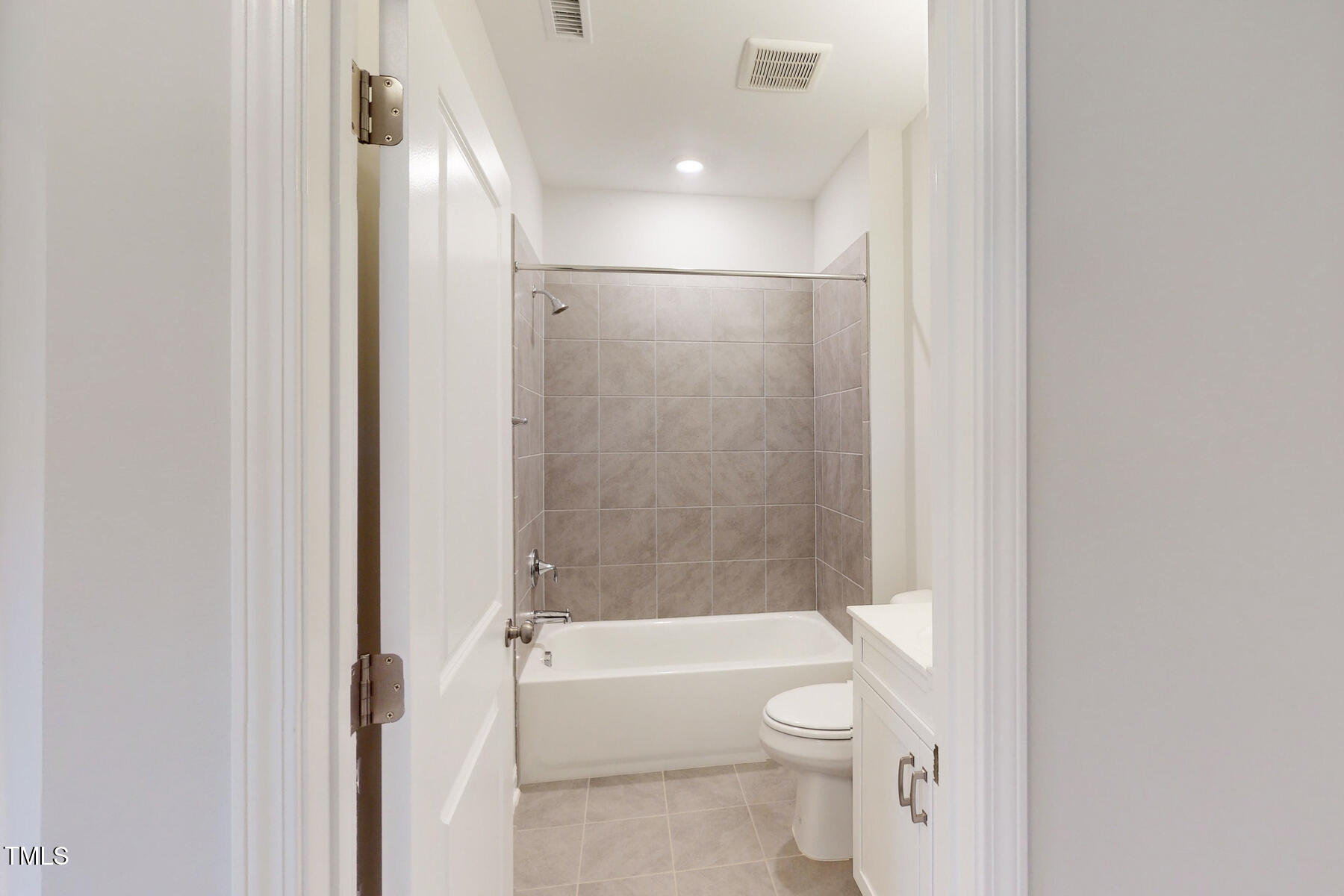 7701 Litcham Drive Raleigh, NC 27615 - Photo 12 of 58 a bathroom with a toilet and a bathtub
