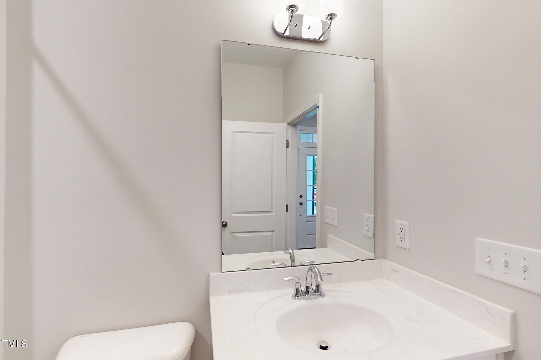 7701 Litcham Drive Raleigh, NC 27615 - Photo 13 of 58 a bathroom with a sink a toilet and mirror