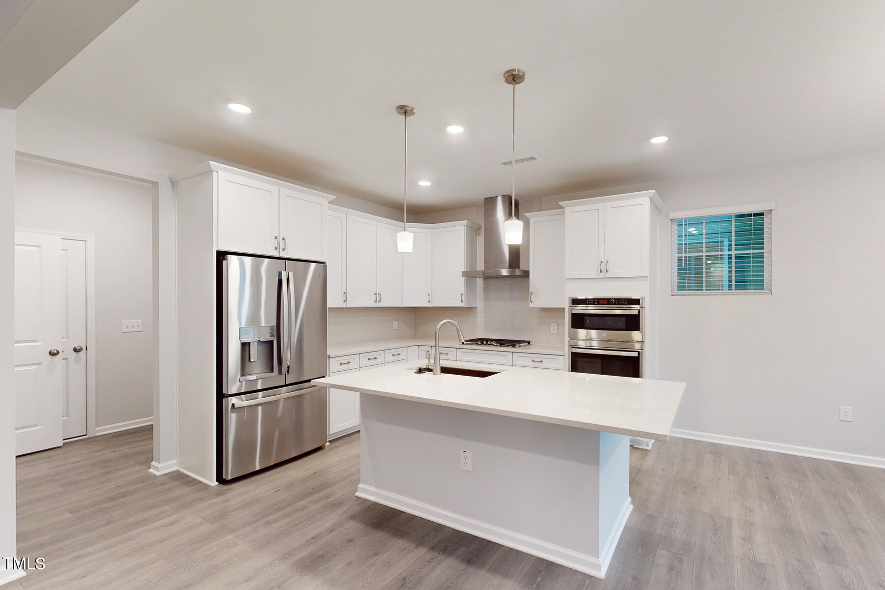 7701 Litcham Drive Raleigh, NC 27615 - Photo 18 of 58 a kitchen with stainless steel appliances a refrigerator sink and microwave