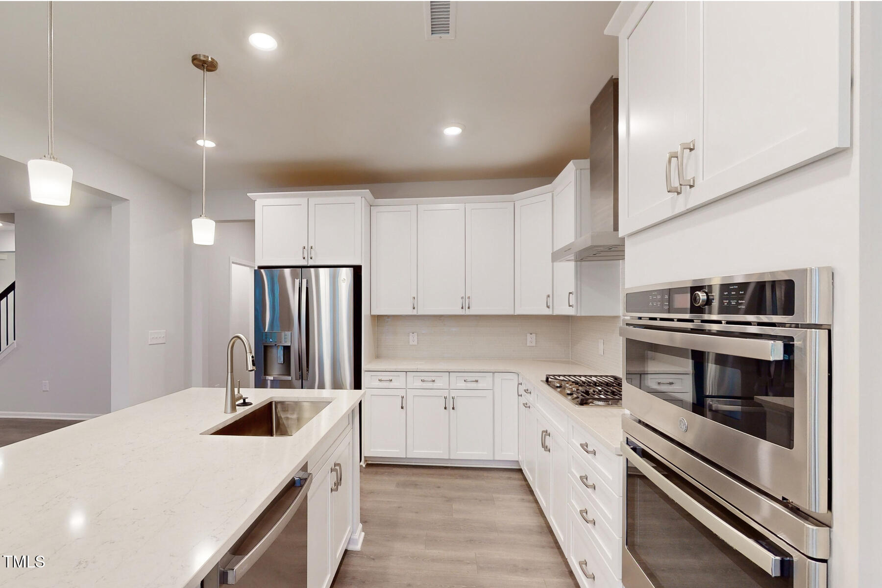 7701 Litcham Drive Raleigh, NC 27615 - Photo 20 of 58 a kitchen with a sink stove and refrigerator