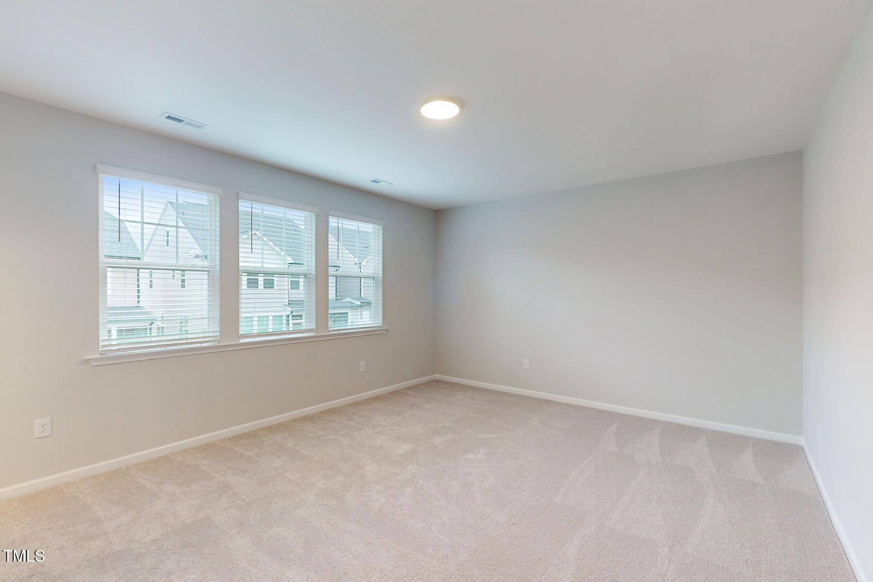 7701 Litcham Drive Raleigh, NC 27615 - Photo 30 of 58 an empty room with windows