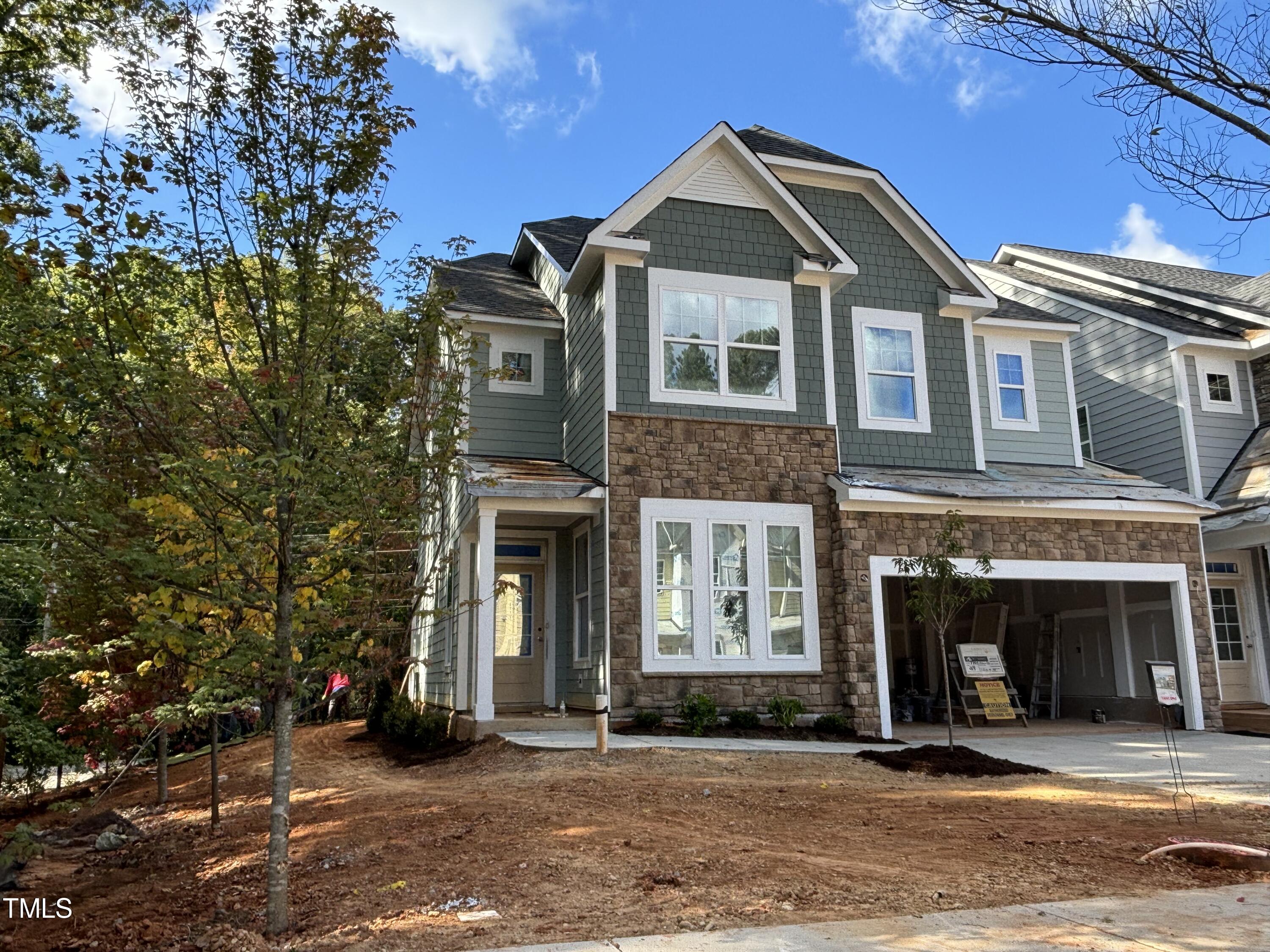 7701 Litcham Drive Raleigh, NC 27615 - Photo 3 of 58 a front view of a house with a yard