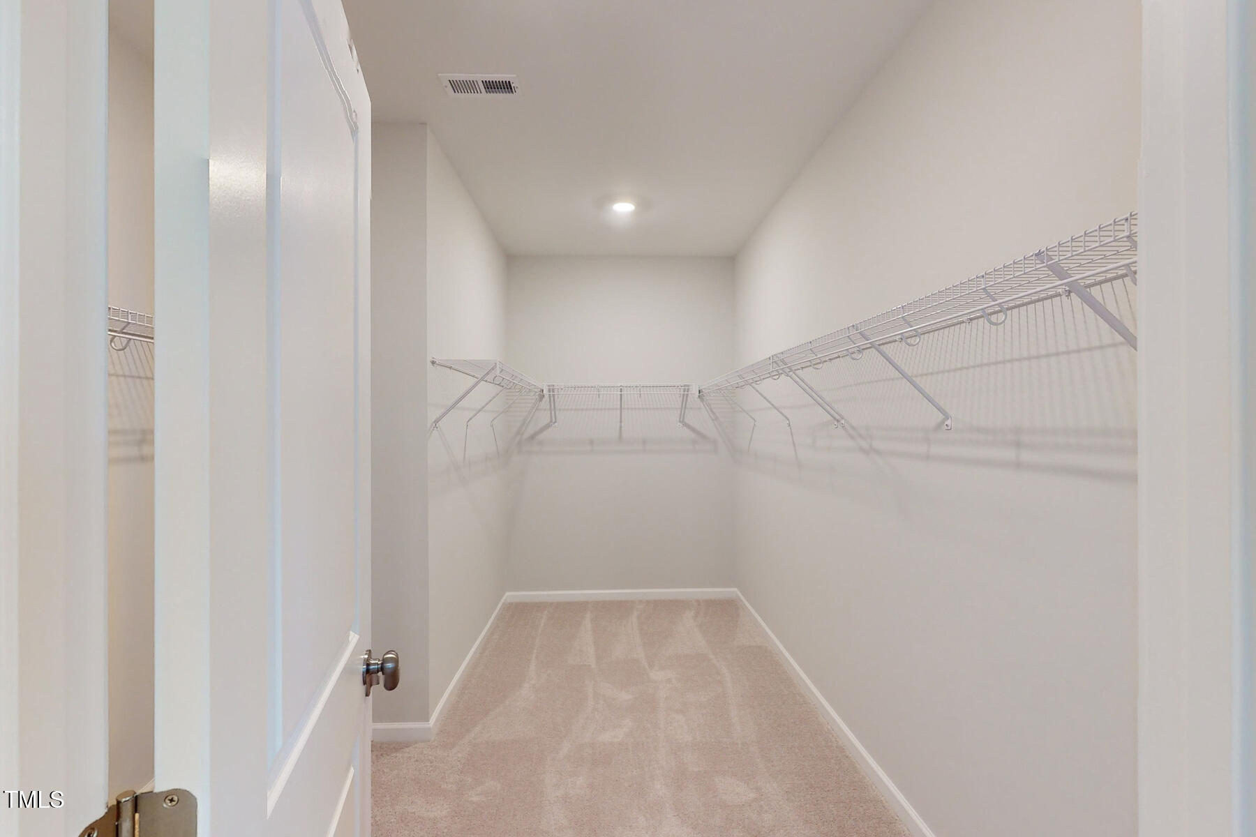 7701 Litcham Drive Raleigh, NC 27615 - Photo 33 of 58 a view of a room with racks on the wall
