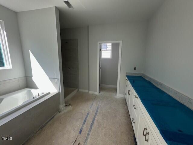 7701 Litcham Drive Raleigh, NC 27615 - Photo 36 of 58 a bathroom with a bathtub and a window