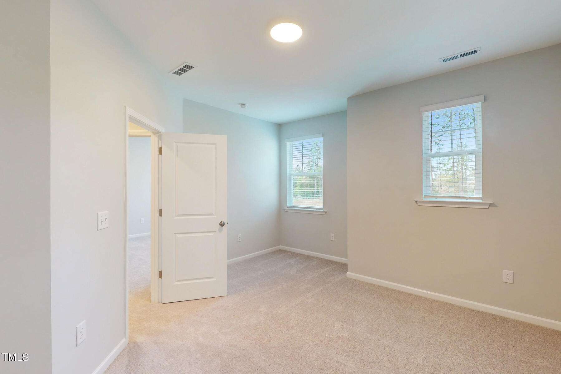 7701 Litcham Drive Raleigh, NC 27615 - Photo 37 of 58 an empty room with windows and closet