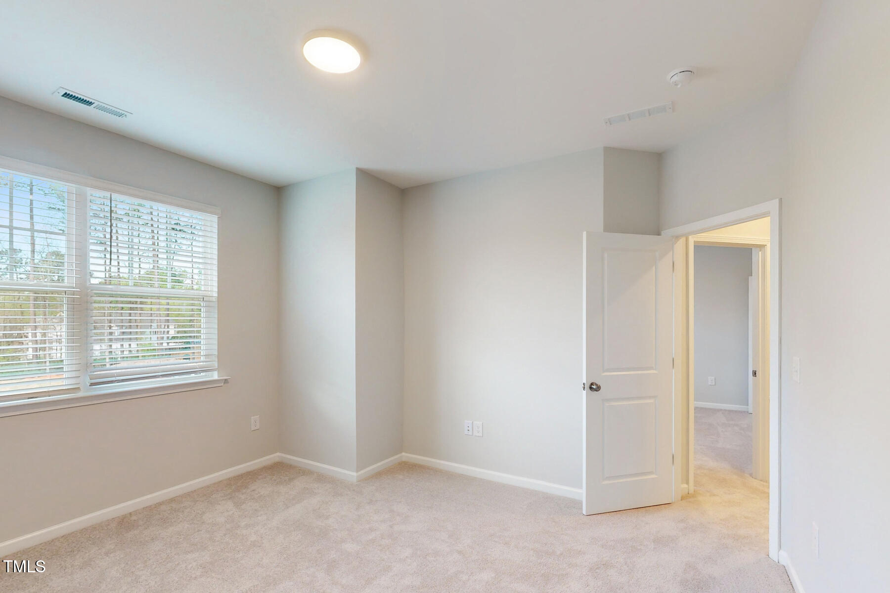 7701 Litcham Drive Raleigh, NC 27615 - Photo 38 of 58 an empty room with a empty space and windows