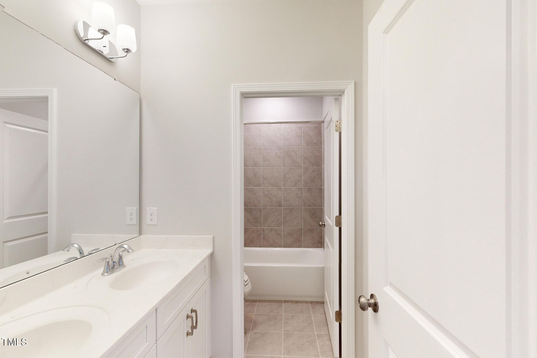 7701 Litcham Drive Raleigh, NC 27615 - Photo 42 of 58 a bathroom with a sink and a mirror