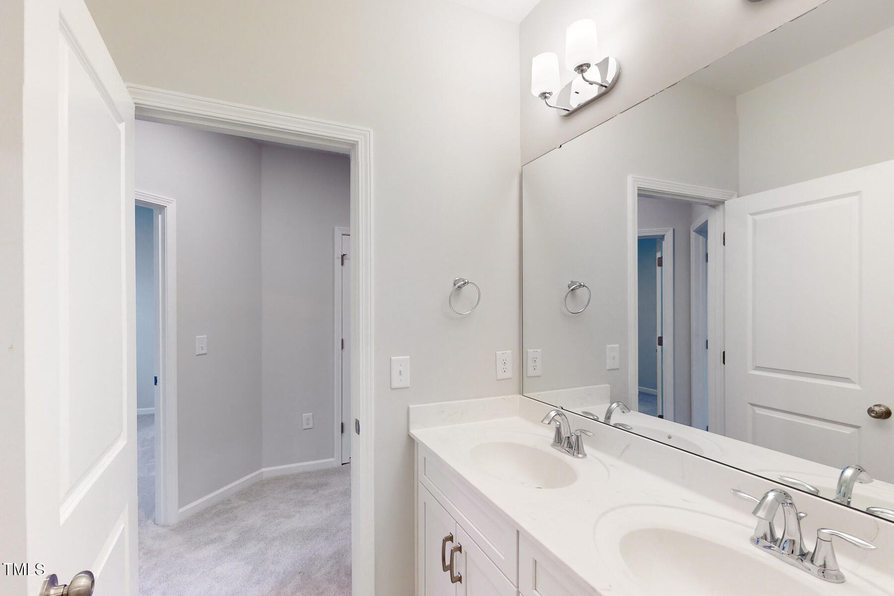 7701 Litcham Drive Raleigh, NC 27615 - Photo 43 of 58 a bathroom with a sink and a mirror